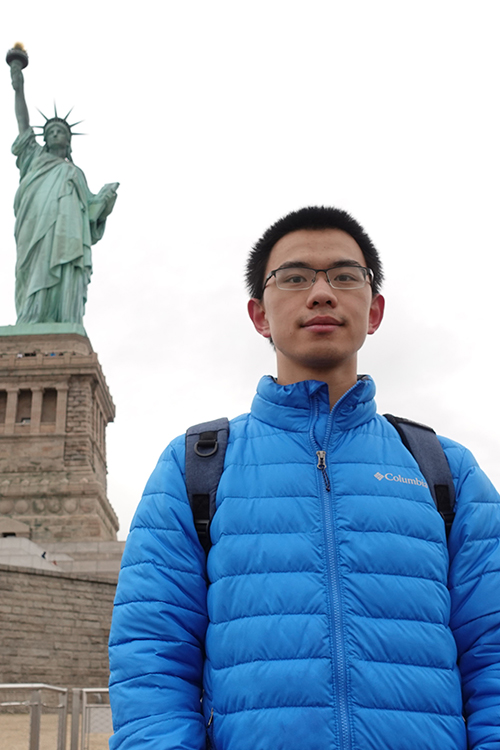 Xinyu Wang in front of the Statue of Liberty